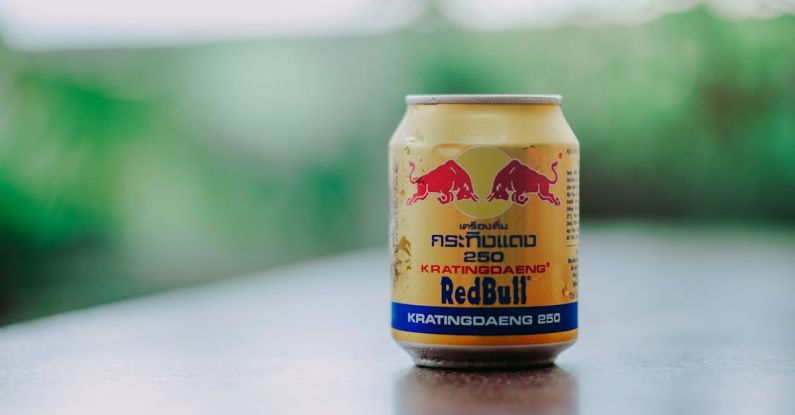 Energy Drinks - Close-up Photography of Red Bull in Can