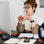 Online Tutoring - Confident elegant lady in eyeglasses hosting webinar