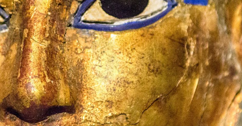 Ancient Artifacts - Human Face Figure with a Golden Color