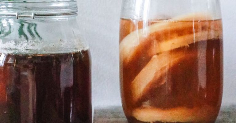 Fermentation - Jars with kombucha and dark herbal beverage