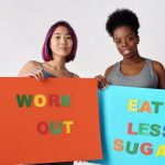 Eating Habits - Women with Posters About Healthy Lifestyle