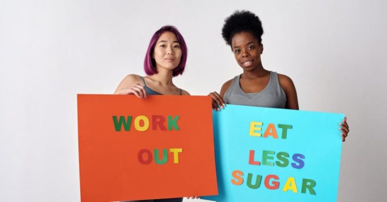 Eating Habits - Women with Posters About Healthy Lifestyle