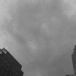 Financial Literacy - Black and white photo of tall buildings with cloudy sky